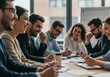 © Vooglo.com - Group of business people laughing during a meeting at the office around a table