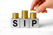 © Charan suvvada  - SIP investment savings financial planning stack coins hand placing money mutual fund return wealth growth personal finance economy concept budget goal systematic investment plan