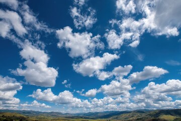 Poster - Vast Blue Sky Filled With White Cumulus Clouds Over Distant Rolling Hills, Representing Openness and Environmental Awareness : Generative AI