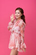© Dialogue Frame - Young Woman in Pink Pattern Dress on Pink Background
