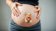 © Sara - Woman pregnant belly with little teddy toy bear. Concept photo with symbol of many meanings for expectant mother during pregnancy and her unborn baby.