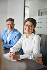 Fototapete - Smiling manager working with partners in office, consulting investor, conducting job interview in boardroom. Busy business people executive team working together talking at group meeting. Vertical.