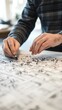 © Khinthong - Architect outlining neighborhood layout on large table