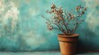 © SUUGOIisME - A weathered terracotta pot with dried flowers sits against a vibrant turquoise wall. creating a rustic yet artistic ambiance. ideal for home decor inspiration