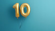 © suldev - Banner with number 10 golden balloon with copy space. thirty years anniversary celebration concept on a blue background