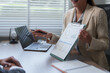 © crizzystudio - Businesswoman showing monthly budget report to her colleague during meeting