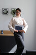 © Andrii Zastrozhnov - Young hispanic female professional holding laptop in modern office