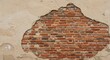 © mdshafiq - Exposed brick wall revealing history and decay, with plaster and texture