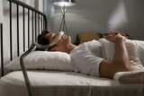 Man sleeping peacefully at night using CPAP machine to treat snoring and obstructive sleep apnea (OSA). Image highlights respiratory health, home therapy, and sleep disorder management.