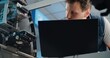© Framestock - Display Screen of ATM Machine. Focus on Technician in Uniform Using Laptop, Adjusting Internal Components and Servicing Automated Teller Machine in Modern Airport Terminal. Cash Withdrawal Systems.