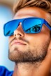 © Studio - A man with a beard wearing a pair of blue sunglasses
