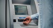 © Framestock - ATM Machine: Unrecognizable Man Entering PIN Code on Keypad, Choosing Money Withdrawal Transaction, Entering Amount and Taking US Dollars from Cash Dispenser. Banking System and Operations. Close Up.