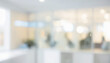 © al-sultan - Blurred interior view with glass walls and white surfaces creating a bright space.