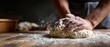 © Fernando - Closeup of adult man kneading dough on a floured wooden table, preparing homemade bread in a rustic kitchen Concept of baking, cooking, and healthy food