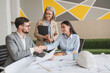 © InsideCreativeHouse - Confident engineer team working with Blue Print with architect equipment discussing and planning work flow construction project with partner at the table in office boardroom
