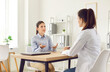 © Studio Romantic - Patient having a medical consultation and conversation with a doctor or nurse in a hospital office. Healthcare professional providing advice and the patient seeking guidance regarding health.