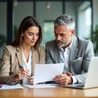 © Tanjina - Business Meeting: Professional Colleagues Reviewing Documents, Discussing Strategy, and Planning in Modern Office.