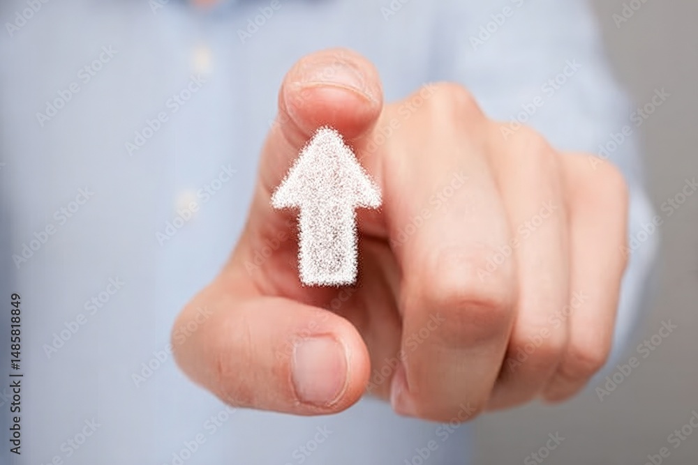 A hand is pointing upwards with a clear white arrow illustration, suggesting direction or highlighting a message. The neutral background and soft focus draw attention to the action.