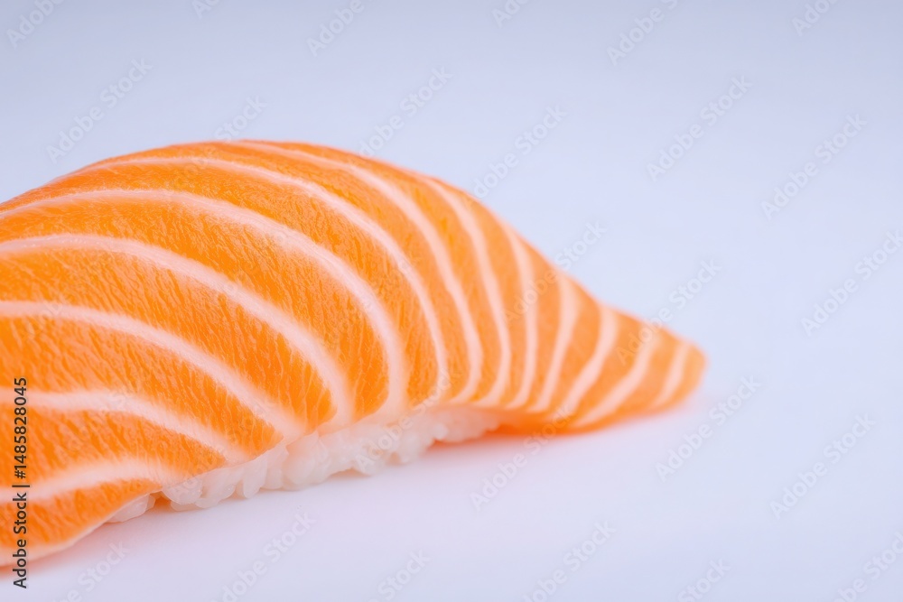 A vibrant piece of salmon sushi showcases its delicate texture and rich color. The sushi is placed on a pristine white background, highlighting its appealing presentation.