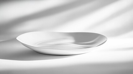 Poster - White oval serving bowl on white background with soft shadows.