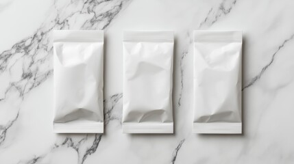 Poster - Three blank white pouches on marble background; packaging mockup.