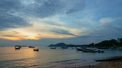 Wall Mural - time lapse clouds float above the sea at sunset. the clouds, illuminated by the setting sun, create 