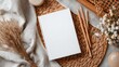 © Fenny - Blank book mockup, cozy aesthetic, featuring natural elements like woven placemats, pencils, and dried flowers