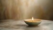© ADI - Burning candle in ceramic bowl soft warm light peaceful mood