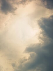 Wall Mural - Beautiful Soft Clouds Forming an Artistic Sky with Light Peeking Through a Natural Landscape, Perfect for Backgrounds, Prints, and Website Designs