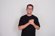 © KrishnaTedjo - A man smiling happy with hands touching his chest