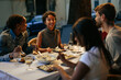 © bernardbodo - Friends enjoying dinner together at outdoor restaurant