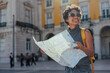 © bernardbodo - Tourist exploring lisbon with map and backpack, enjoying summer vacations in portugal