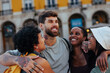 © bernardbodo - Group of happy friends embracing in lisbon, portugal