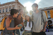 © bernardbodo - Happy tourists using smart phone in lisbon, portugal, exploring european city together