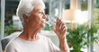 © peopleimages.com - Home, drinking water and old woman in lounge, wellness and hydration with morning routine. Nutrition, pensioner and elderly person with liquid, thirsty and aqua with health in retirement and detox