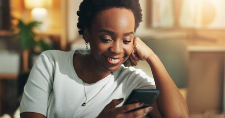 Poster - Black woman, smile and relax with phone in home for social media scroll, reading online news and streaming service. Night, person and internet connection on sofa for dating site, browse and blog post