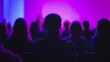 © Gro - Audience Silhouettes Watching Event with Purple and Blue Light