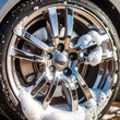 © Simon - Close-up of shiny car wheel with soap suds