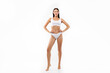 © Home-stock - Full length shot of beautiful lady posing in white underwear bra and panties over white studio background, demonstrating nice curves