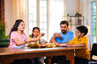 © StockImageFactory - Indian family enjoying golgappa at home while sharing love, laughter, and delicious street food