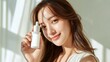 © Chirawan - Smiling Young Woman Holding Skincare Bottle