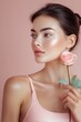 © The Little Hut - Portrait of a young woman with glowing skin, holding a delicate pink rose against a soft pink background. Her beauty is enhanced by subtle makeup and a gentle expression. : Generative AI