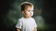 © Kamonwan - A thoughtful toddler gazes out a window as rain falls softly, capturing a moment of contemplation and innocence. The soft light emphasizes the child's expression and mood.