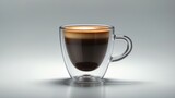 Isolated glass of hot espresso with foam on dark background