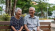 © Desmond - Elderly Asian friends relaxing on a wooden bench in a peaceful city park, laughing and enjoying each other’s company, natural light, candid and warm atmosphere.