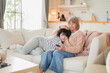 © whyframeshot - family concept lovely mother and daughter lying down embrace bonding relation stay home spending good moment conversation smartphone at home