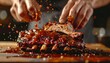 © Simon - Juicy barbecue ribs with sauce drizzle and hands preparing meal