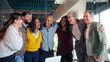 © CarlosBarquero - Professional team celebrating successful project milestone, sharing joyful moment of unity and laughing together in modern office workspace, highlighting collaborative workplace achievement