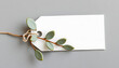 © Yusuf - Rectangle white gift tag mockup with eucalyptus leaves on grey background, label tag mockup, Wedding favor tag for souvenir, sign for greeting message close up, element for design, close up, craft c
