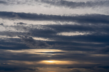 Wall Mural - clouds sunset sky: atmospheric layers during sunset showcasing varied cloud formations and sunlight.